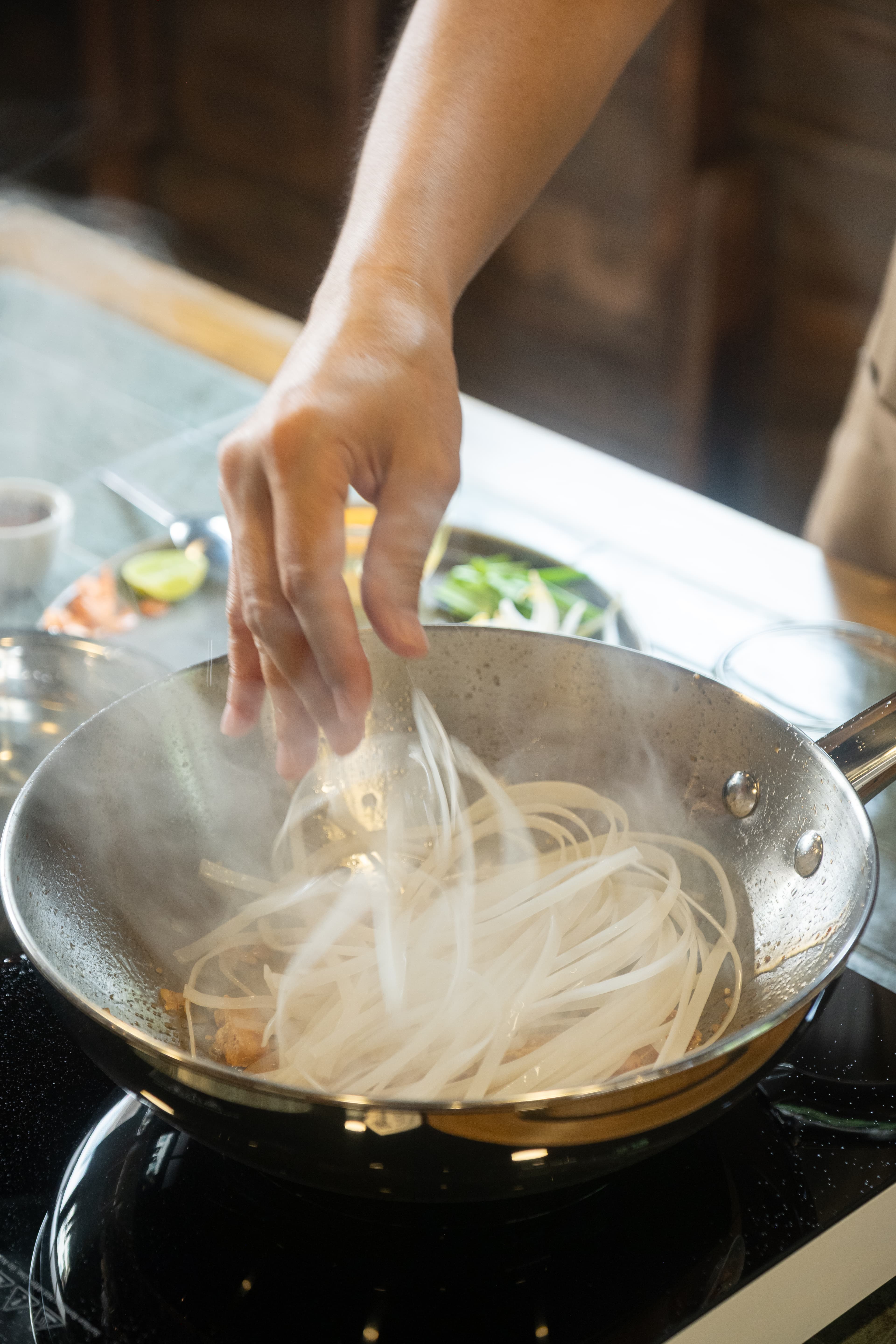 Family cooking together in Thai kitchen